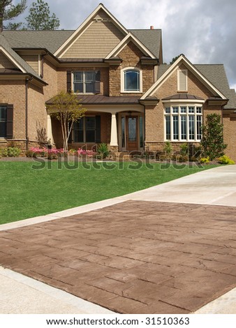 Luxury Model Home Exterior with stone driveway
