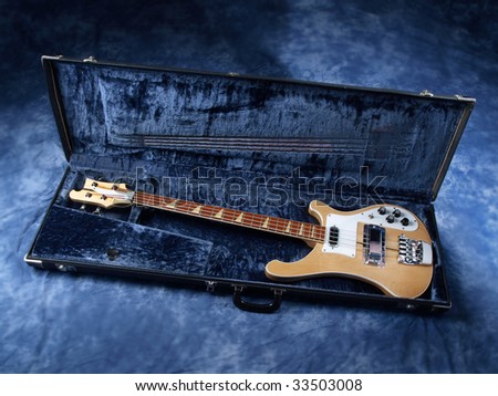 Bass Guitar light colored wood in blue case
