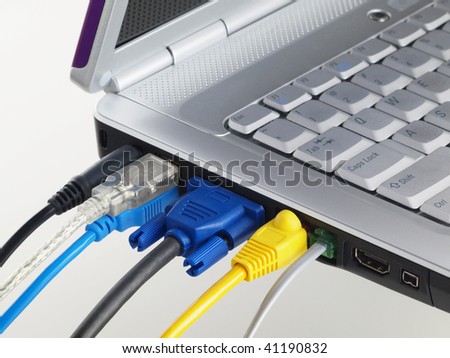 Laptop with muliti color plugged in ports on white