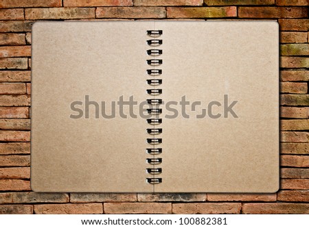 notebook on the brick background