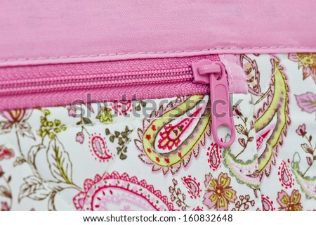 pink zip on a bag background