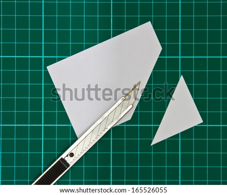 Cutter Knife Cutting white paper on cutting mat
