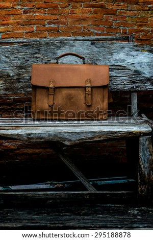 Brown Leather laptop bag corporate  on old woden chair