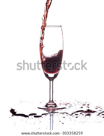 red wine pouring into wine glass isolated on white