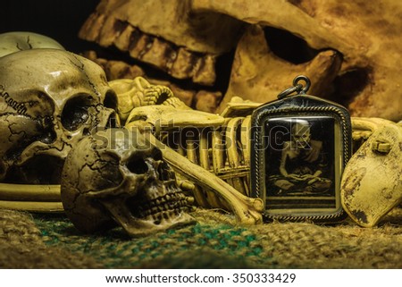 small buddha with human skull still life background