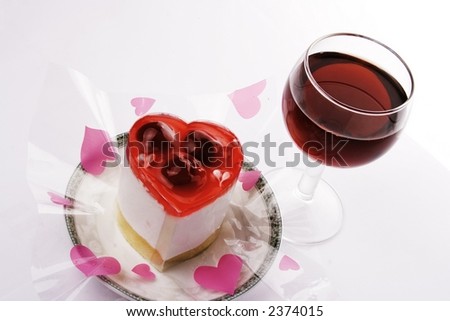 A Red wine with love shape dessert.