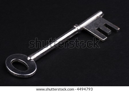 A Silver skeleton key in isolated black background.
