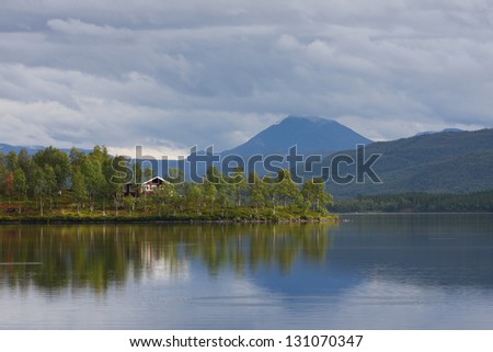 panorama view of the wooden houses  on a lake coast, norway