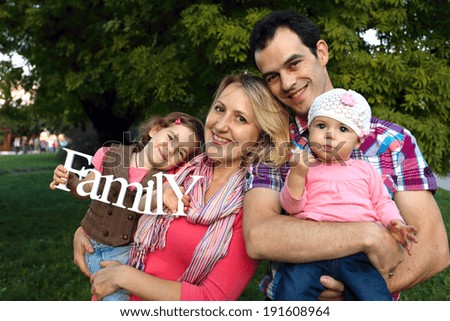 happy family with smiling faces outdoors