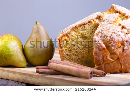 pear pie and pears on wooden board