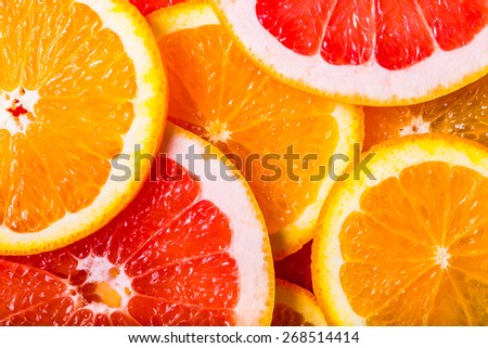 background made with a heap of sliced oranges and grapefruits