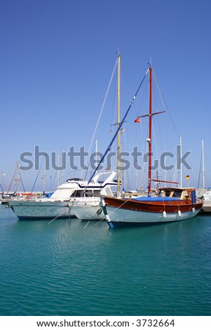 group of yachts moored at sunny bay