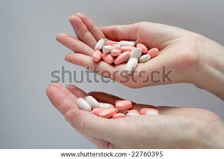 woman pouring a pills from one hand to another