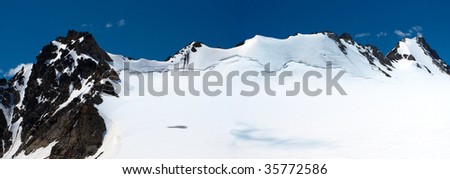 high resolution panoramic view of snowed mountain range. Made of two pictures