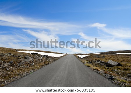 road to heaven. Empty road receding into the distance and the blue sky at the background