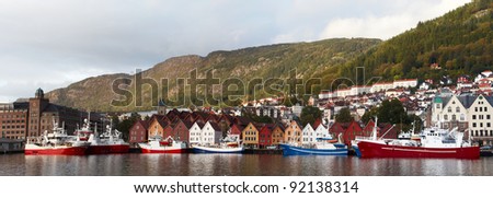 panoramic view of a sea-front of a bergen with ships in the foreground, norway