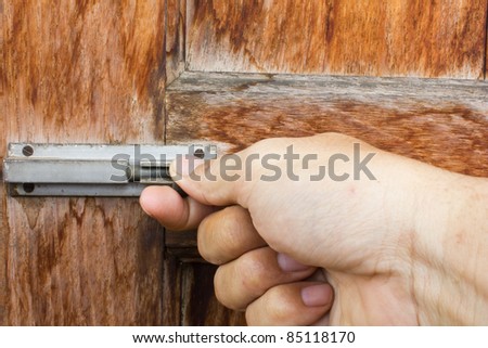 Hand on an antique door - opening
