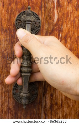 Handle to open the old wooden door.