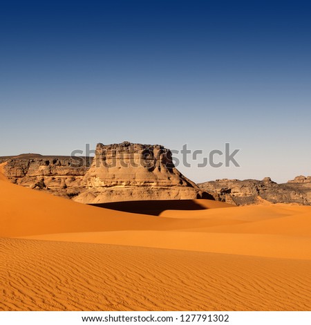 The Libyan desert - a fantastic place for travelers and photographers. Rocks of an unusual form, beautiful structure of dense yellow sand, dune of the huge sizes and