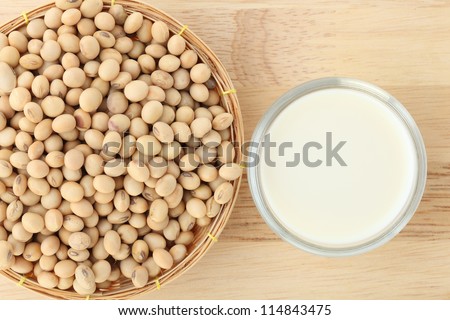 soy milk with soy beans on wood background