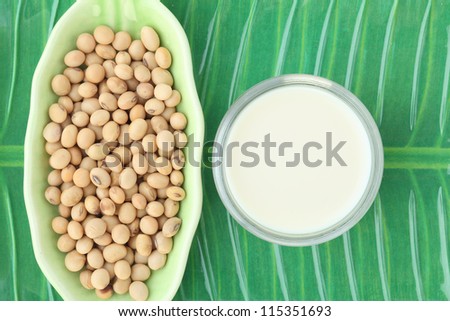 soy milk with soy beans on green tray background