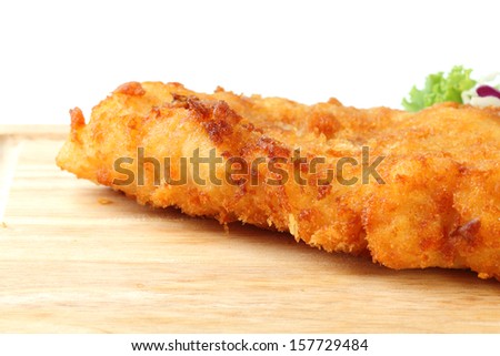 fried fish fillet with vegetables on white background