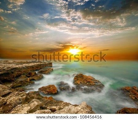 Sea cliffs and sunset over the sea. The natural composition