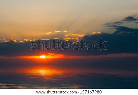 Sunset on the sea. The setting sun on the sea background