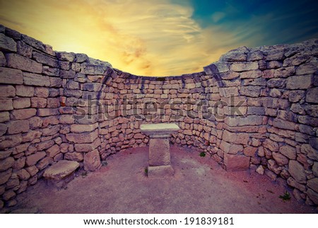 The ruins of an ancient altar in the Greek temple on sunset. Vintage style