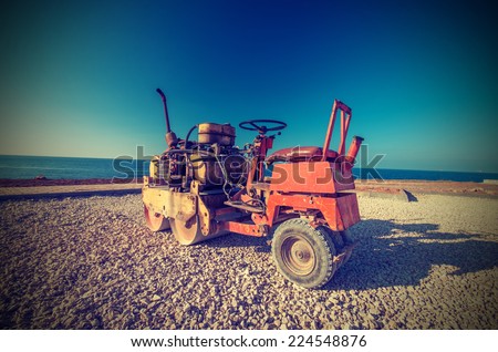 Old Roller (paver) prepare the ground for the laying of asphalt. Vintage style
