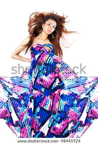 Asian girl posing in vivid dress and with flowing hair