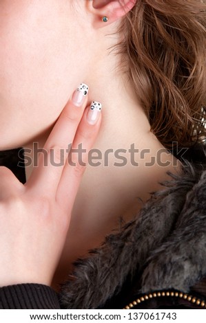 Woman checking her heart heart rate holding her fingers to her neck