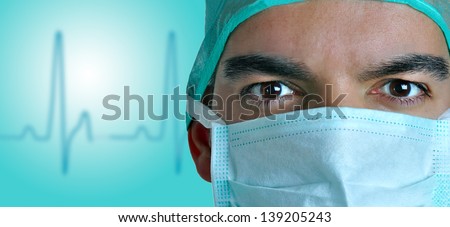 Closeup portrait of a surgeon with a EKG wake behind him. Blue color cast on the doctors face.