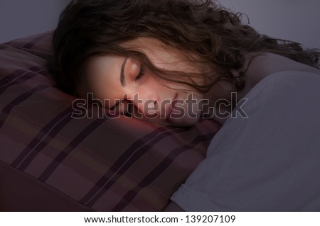 Young woman sleeping on a red pillow