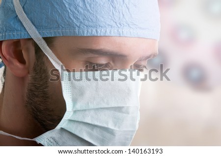 Surgeon during a surgery with a strong light flare coming from the operation room lights