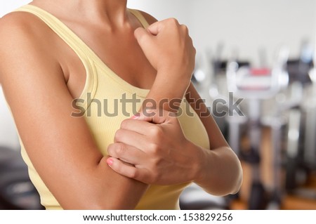 Female with pain in her forearm in a gym