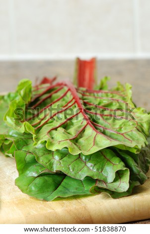 Red chard leaves on a cutting board