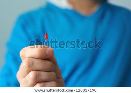 Engineer holding red LED light in hand