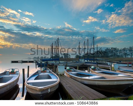 Rental boats in an harbor during sunrise
