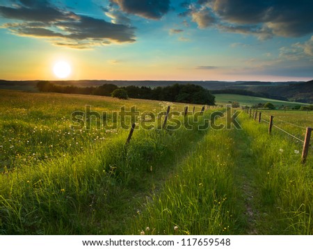 Trail is Disappearing on the Horizon in German Countryside with Hills