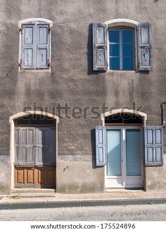 Facade of an Old French House With Window Panes and Window Shutters