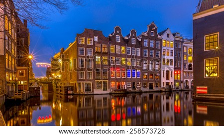 Traditional colorful canal houses at night seen from the Sint Olofsteeg on the Oudezijds Voorburgwal in the UNESCO World Heritage site of Amsterdam
