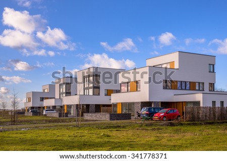 Modern geometric family houses along a green modern residential suburban street, Groningen, Netherlands