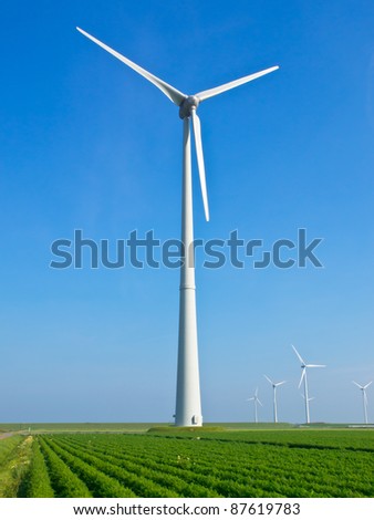 Giant wind turbine in dutch agricultural landscape