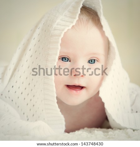 Little baby with Down syndrome hid under blanket