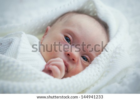 newborn with Down syndrome is quiet and looks