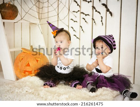 Girl with Down syndrome and her friend eat candy on a holiday halloween