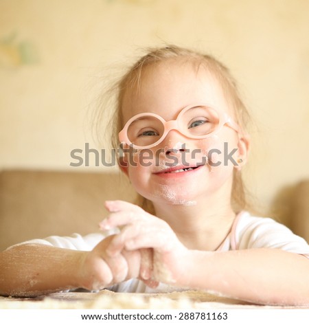 Girl with Down syndrome playing flour