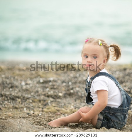 beautiful girl with Down syndrome on the beach