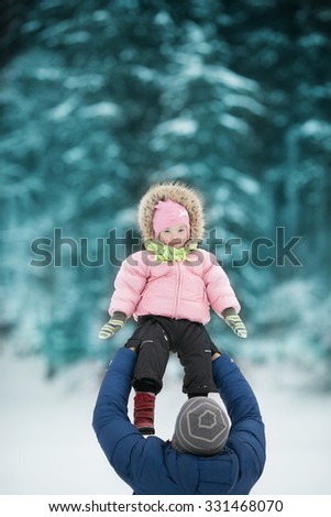 Dad throws daughter with Down syndrome in the winter forest